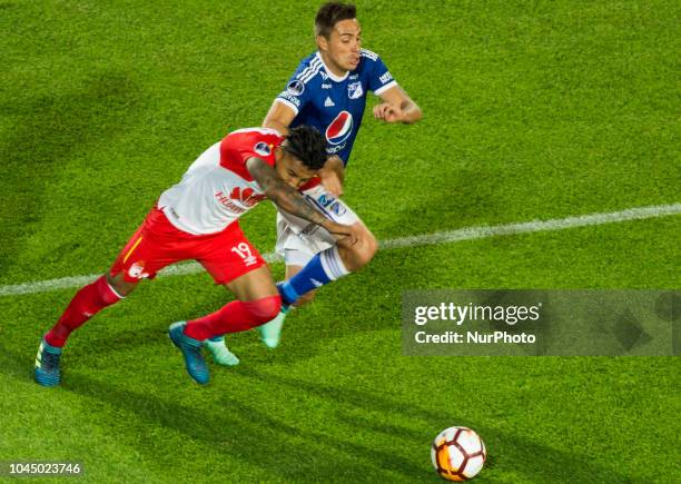 Wilson Morelo of Independiente Santa Fe defends the ball against a Millonarios player during Copa Sudamericana match between Millonarios and...