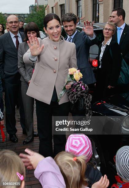 Danish Crown Prince Frederik and Danish Crown Princess Mary, who is pregnant with twins, greet onlookers upon their arrival at the High School for...