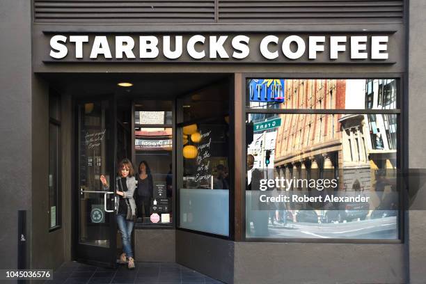 Customer leaves a Starbucks Coffee shop in San Francisco, California.