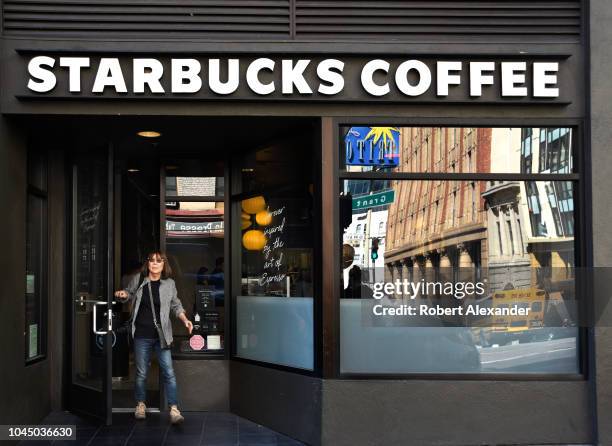 Customer leaves a Starbucks Coffee shop in San Francisco, California.