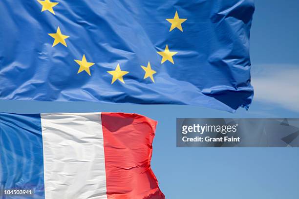view of two flags in wind - european culture stock pictures, royalty-free photos & images