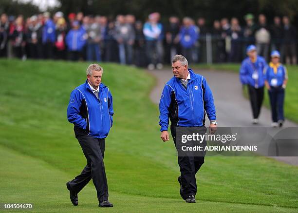 Europe Ryder Cup team captain vice-captain Darren Clarke speaks with captain Colin Montgomerie during a practice session at Celtic Manor golf course...