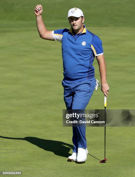 Jon Rahm of Spain and the European Team acknowledges the crowds after winning the first hole with a bordie against Tiger Woods of the United States...