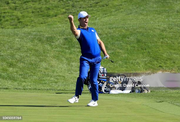 Paul Casey of the European Team celebrates holing a long birdie putt to win the second hole in his match against Brooks Koepka of the United States...