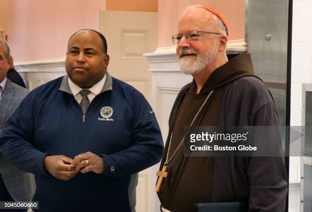 Lawrence Mayor Dan Rivera, left, and Cardinal Sean O'Malley walk together into the Cor Unum Meal Center in Lawrence, MA, where the volunteer staff...