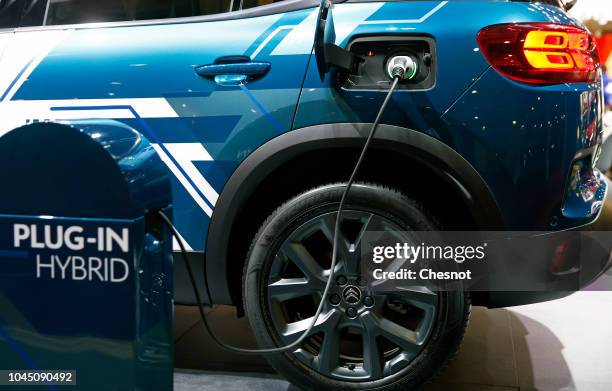 An electric charger for a Citroen SUV C5 Air Cross plug-in hybrid automobile is on display during the second press day of the Paris Motor Show at the...