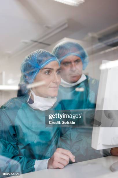 nurse and doctor looking at computer - double exposure technology stock-fotos und bilder