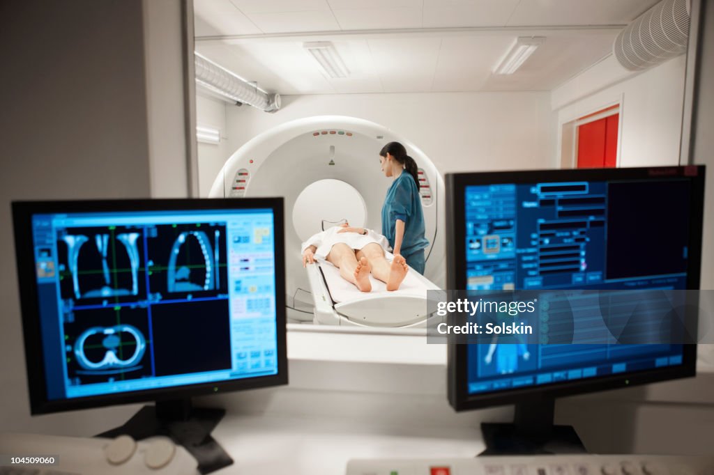 Nurse with patient laying in ct-scanner