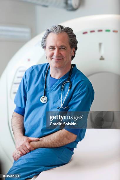 doctor in front of ct-scanner - scandinavian descent stock pictures, royalty-free photos & images