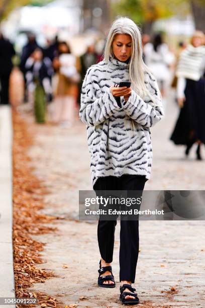Sarah Harris wears a black and white zebra print pullover, outside Beautiful People, during Paris Fashion Week Womenswear Spring/Summer 2019 on...