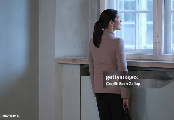 Danish Crown Princess Mary, who is pregnant with twins, pauses to look out of a window while touring Schloss Guestrow palace with her husband Danish...