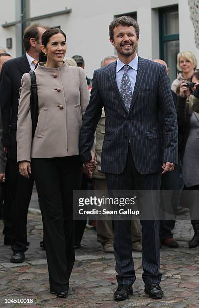 Danish Crown Prince Frederik and Danish Crown Princess Mary, who is pregnant with twins, walk in the city center on September 28, 2010 in Guestrow,...