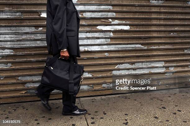 Man walks by a shuttered store in an economically depressed neighborhood on September 28, 2010 in the Brooklyn borough of New York City. A new report...