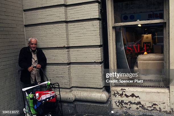 Man waits for a bus next to a retail store on September 28, 2010 in the Brooklyn borough of New York City. A new report released by the U.S. Census...