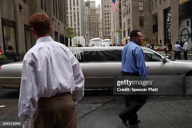Men walk in front of a stretch limousine on September 28, 2010 in New York City. A new report released by the U.S. Census Data shows that the income...