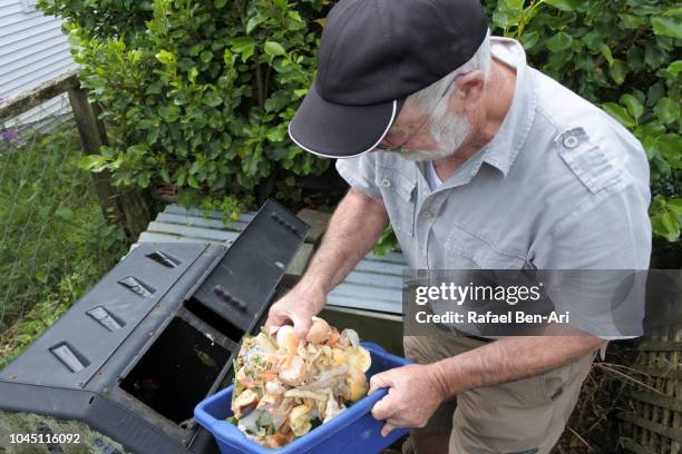 adult senior man composting food waste - pourrir photos et images de collection