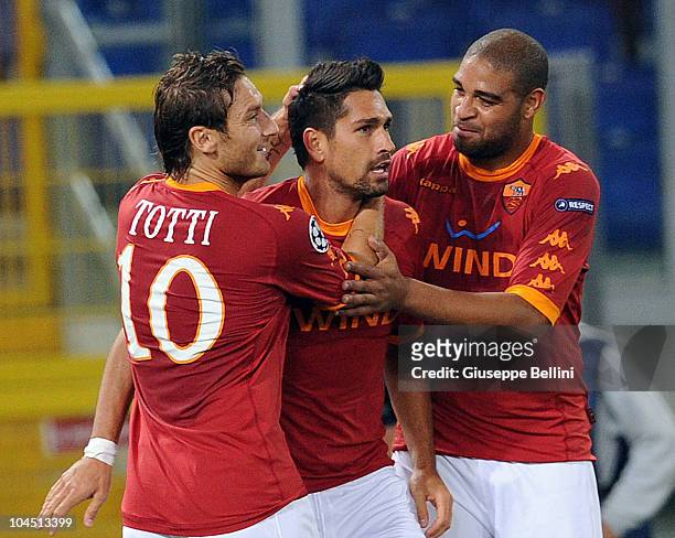 Marco Borriello of Roma is congratulated by team-mates Francesco Totti and Adriano after scoring the goal 2-0 during the UEFA Champions League group...