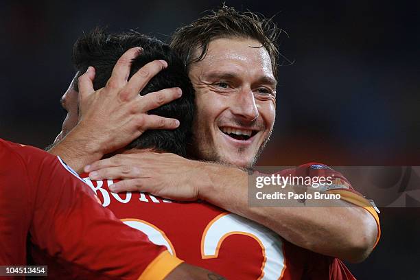 Francesco Totti congratulates Roma team-mate Marco Borriello for scoring their team's 2-0 goal during the UEFA Champions League group E match between...
