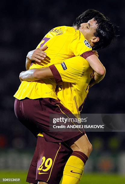 Marouane Chamakh and Tomasz Rosicky of Arsenal FC celebrate after scoring against Partizan Belgrade during their UEFA Champions League Group H...