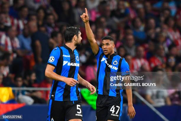 Club Brugge's Dutch forward Arnaut Danjuma celebrates with Club Brugge's French defender Benoit Poulain after scoring during the UEFA Champions...