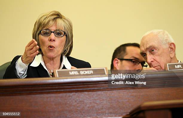 Sen. Barbara Boxer speaks as Committee Chairman Sen. Frank Lautenberg listens to an aide during a hearing before the Senate Commerce, Science and...