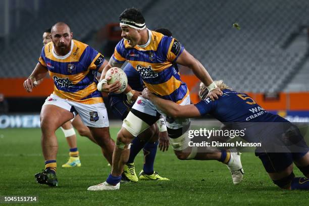 Kane Le'Aupepe of Bay of Plenty is tackled by Josh Dickson of Otago during the round eight Mitre 10 Cup match between Otago and Bay of Plenty at...