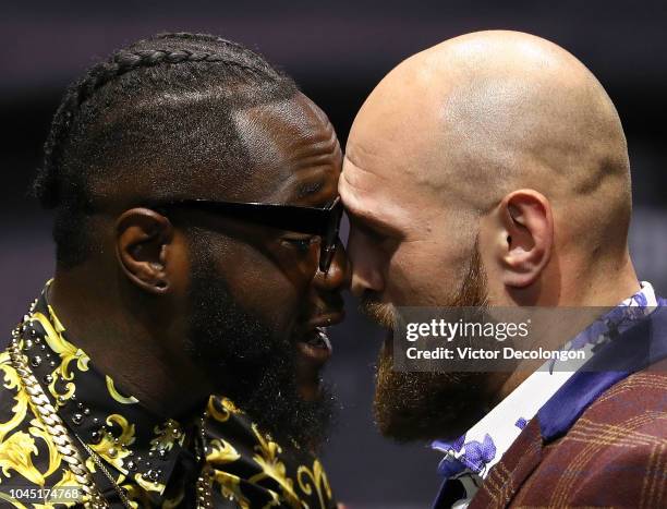 Professional boxers Deontay Wilder and Tyson Fury butt heads onstage during their press conference to promote their upcoming December 1, 2018 fight...