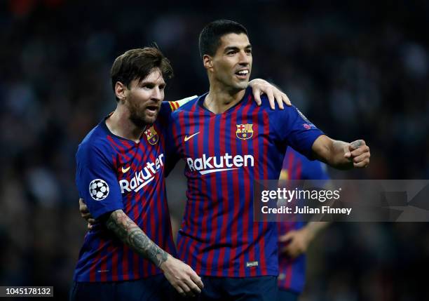 Lionel Messi of Barcelona celebrates scoring his teams fourth goal with Luis Suarez during the Group B match of the UEFA Champions League between...