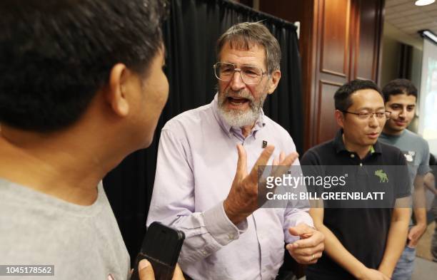 University of Missouri Professor George P. Smith talks with a former student following a press conference announcing he has won the 2018 Nobel Prize...