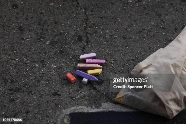 The remaining chalk Sophie Sandberg uses to draw a quote on the sidewalk from a catcall made towards a woman on October 3, 2018 in New York City....