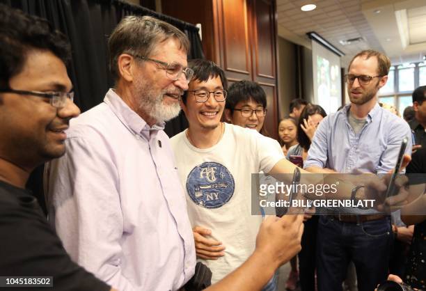 University of Missouri professor George P. Smith has his photograph taken with former student following a press conference announcing he has won the...