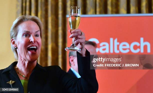 Scientist and Nobel Prize winner Frances Arnold raises a glass of champagne in celebration with students, faculty and attendees on October 3, 2018 at...