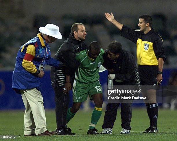 Abram Nteo of South Africa is helped from the ground after sustaining an injury during the Men's Group D football match against Japan during the...