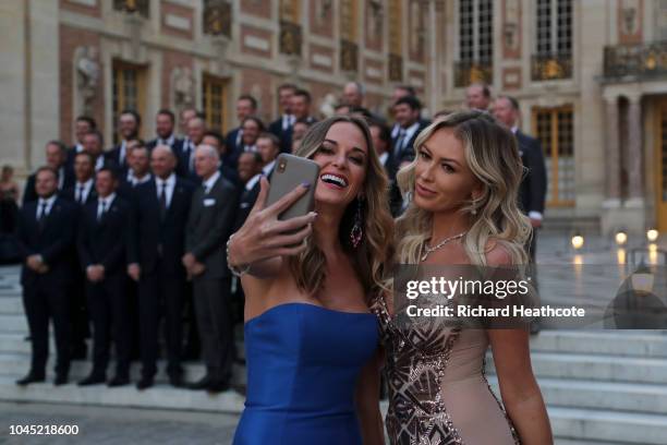 Brooks Koepka's partner, Jena Sims, takes a selfie with Dustin Johnson's partner, Paulina Gretzky, before the Ryder Cup gala dinner at the Palace of...