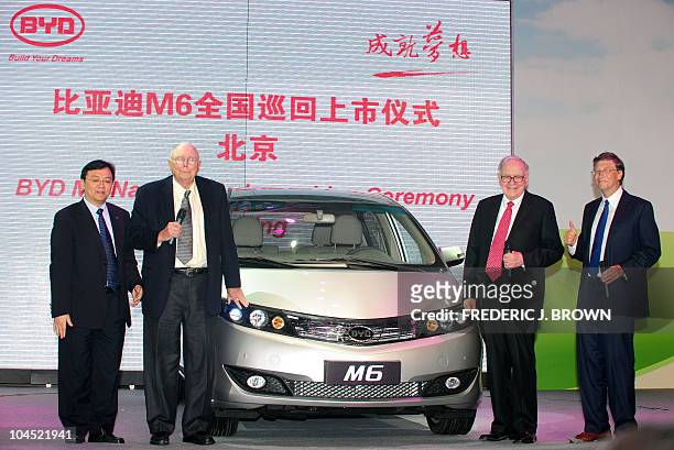 Businessman Bill Gates gestures while standing on stage with fellow billlionaires Warren Buffett , Charles Munger and Wang Chuanfu , the head of BYD,...