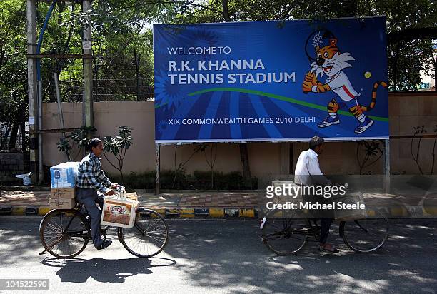 Local traders pass by the R.K Khanna tennis complex ahead of the Delhi 2010 Commonwealth Games on September 29, 2010 in Delhi, India.