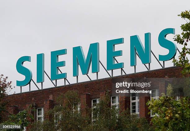 The Siemens AG company logo sits on display at the factory in Berlin, Germany, on Tuesday, Sept. 28, 2010. Siemens AG, Europe's largest engineering...