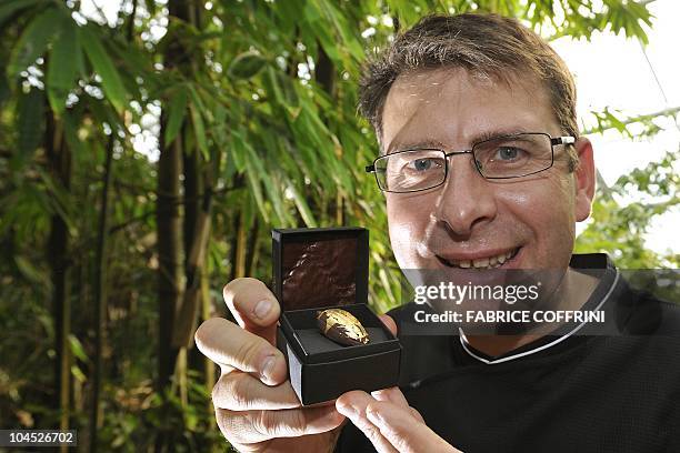 Chocolate maker Francois Stahl poses with a piece of his chocolate creation inside the Zurich zoo's Masoala rainforest giant greenhouse on September...