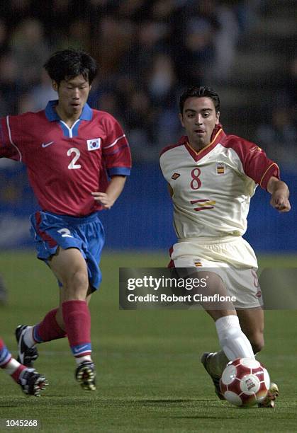 Park Ji Sung for Korea chases down Xavi for Spain during the Mens Prelimanary Olympic Soccer match between Spain and Korea at the Hindmarsh Stadium,...