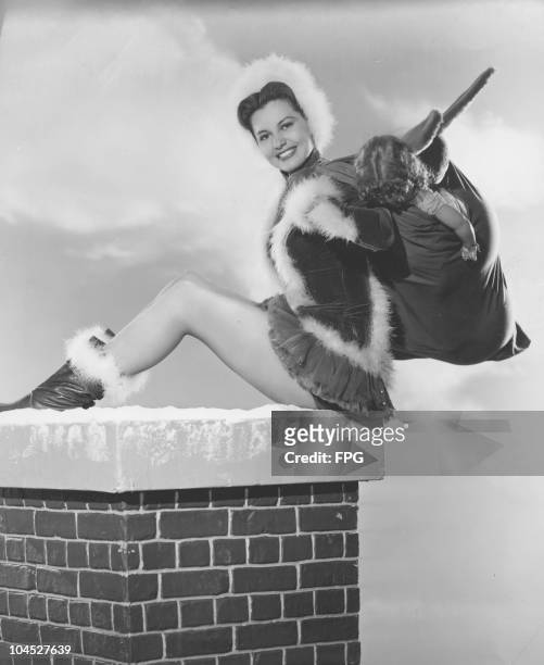 Portrait of American actress and dancer Cyd Charisse dressed in a Santa outfit, circa 1940s.