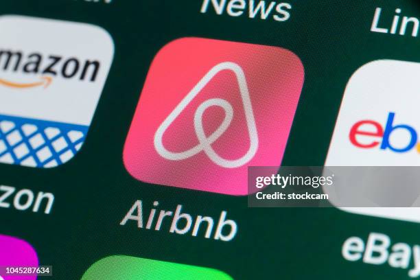 airbnb, amazon, ebay, news and other apps on iphone screen - airbnb stock pictures, royalty-free photos & images