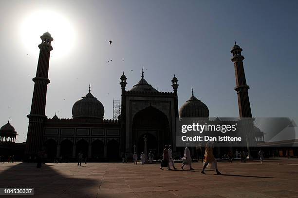 People walk in front of the Jama Masjid Mosque on September 29, 2010 in Delhi, India.