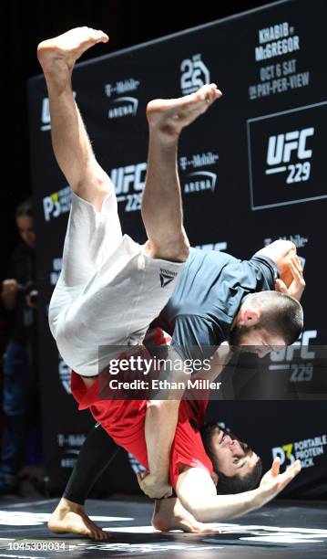 Lightweight champion Khabib Nurmagomedov flips a sparring partner during an open workout for UFC 229 at Park Theater at Park MGM on October 03, 2018...