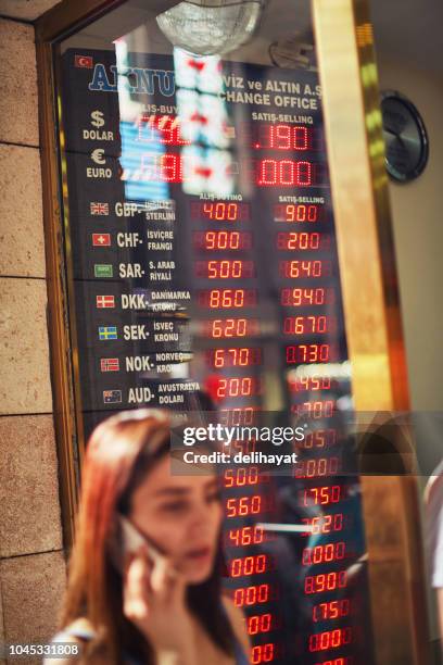 in front of currency exchange office - devaluation stock pictures, royalty-free photos & images