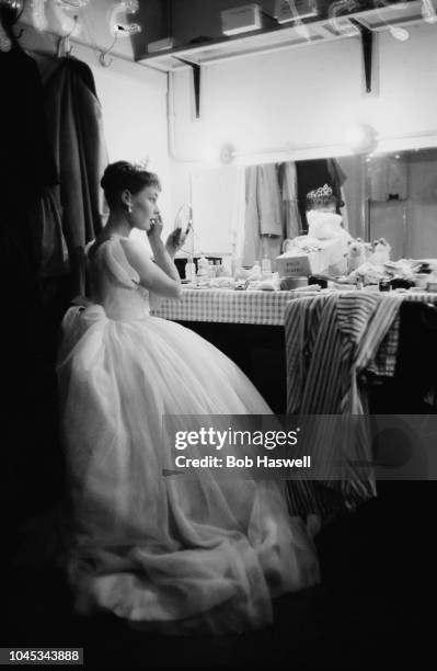 English actress Judi Dench in her dressing room during dress rehearsals for 'Hamlet' at the Old Vic theatre, London, 11th September 1957. Dench is...