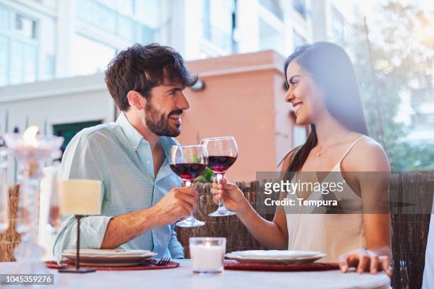 romantic dinner - young couple dining stock pictures, royalty-free photos & images