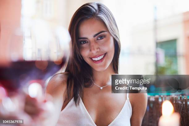 beautiful colombian woman wine toasting pov. - table for two stock pictures, royalty-free photos & images