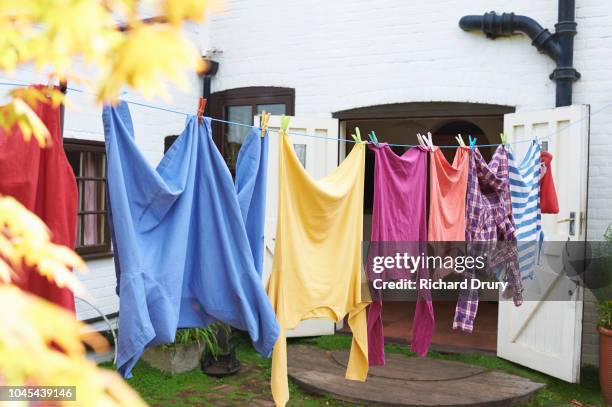 clothing hanging on the washing line - hanging clothes stock pictures, royalty-free photos & images