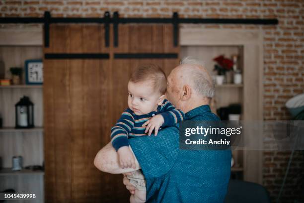 grandfather playing with his little grandchild - active baby boomer stock pictures, royalty-free photos & images