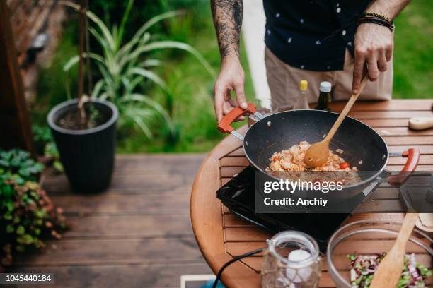 chef stirring risotto - outdoor kitchen stock pictures, royalty-free photos & images